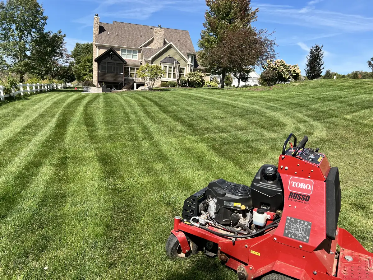 Professional mowing stripes on a residential lawn in Aurora, IL created by Better Turf and Snow crew using a Toro commercial mower